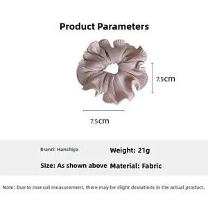 Detail view of light pink pleated fabric hair scrunchie with 7.5cm size measurement