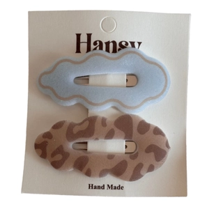 Set of two leopard print and light blue cloud hair clips on card display