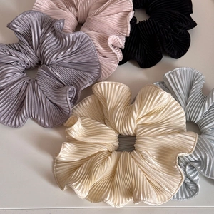 Close-up of pleated satin scrunchies in five colors with high-elasticity ruffles texture
