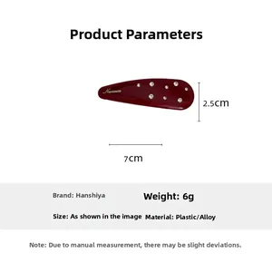 Detail view of the red rhinestone hair clip showing 7cm by 2.5cm size dimensions