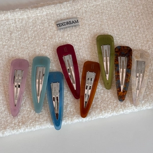 Detailed set of eight waterdrop-shaped acetate hair clips with France Handmade text