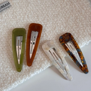 Detailed close-up of four acetic acid teardrop hair clips with France Handmade gold stamp