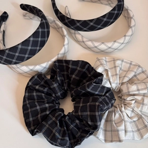 Detail of handmade black and white checkered headband and scrunchie set on white background