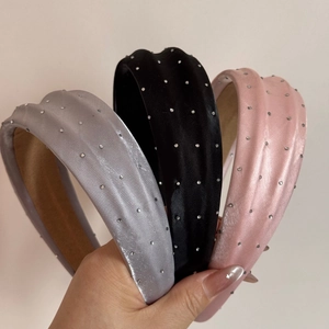 Vue détaillée des serre-têtes rembourrés avec strass en gris, noir et rose soie