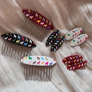 Colorful Dala horse pattern hair comb and clip set on soft cream fabric background