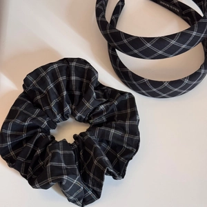 Detailed view of the handmade black and white plaid headband and matching scrunchie set