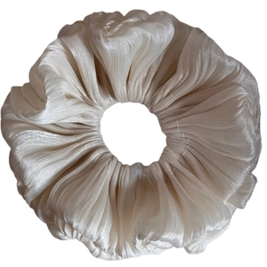 Elegant champagne gold pleated scrunchie with a silk-like glossy finish for hair styling