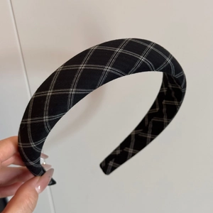 Detail of vintage black and white checkered fabric headband with thick padded design