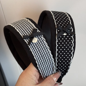 Elegant wide headband with black and white patterns, lace trim and ribbon bow