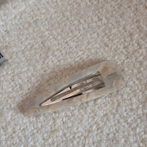 Close-up of cream marble acetate hair clip with silver clip and France Handmade logo