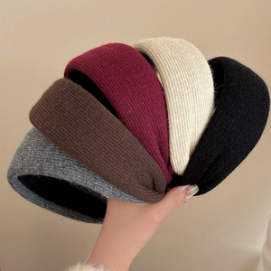 Detail of five thick knitted headbands in grey, coffee, wine red, beige, and black colors