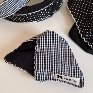 Close-up of black and white gingham fabric headband with lace trim and bow detail
