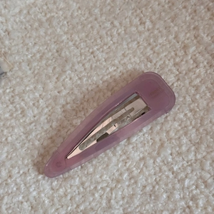 Detail shot of purple translucent acetate teardrop hair clip on soft white fleece