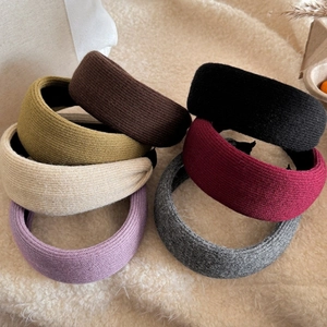 Close-up of wide knitted headbands in multiple colors with non-slip inner lining