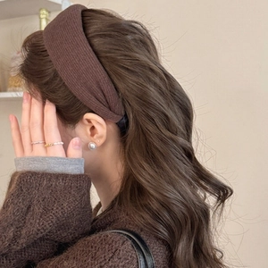 Detail of coffee brown knitted wide headband showing soft vertical striped texture