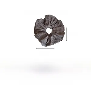 Detail view of large grey plaid fabric scrunchie with 20cm by 20cm size dimensions