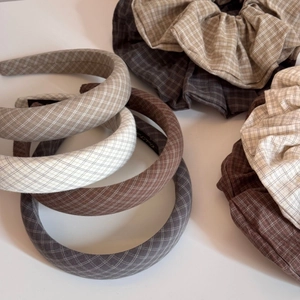 Detail showing vintage plaid fabric hair scrunchies and padded headbands in earth tones