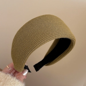 Close-up of olive green wide padded headband showing thick knit texture and soft lining