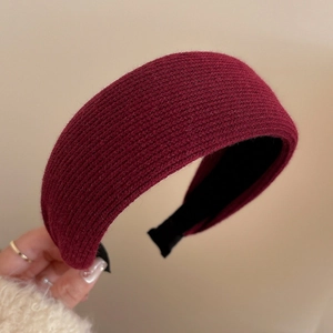 Detail of burgundy knitted thick headband showing texture and non-slip interior lining