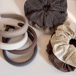 Close-up of vintage plaid fabric headband and scrunchie set in earthy neutral tones