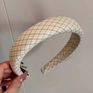 Detail of vintage beige and brown plaid fabric texture on padded sponge headband