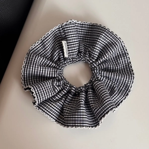 Detailed view of handmade vintage black and white checkered collar with lace trim