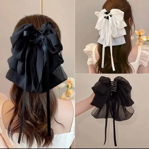 Detail of large chiffon bow hair clips in black and white with sturdy claw clip design