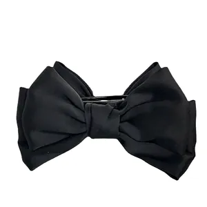 Grande pince à cheveux avec nœud en tissu noir mat pour coiffures élégantes
