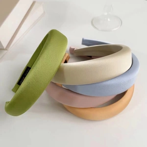 Close-up of colorful padded waffle hairbands with a handmade label on white desk