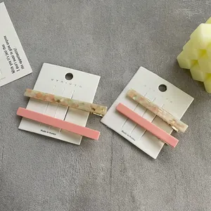 Minimalist resin hair clip set with amber texture and solid pink color for women