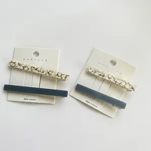 Elegant acrylic and navy blue hair clip set on display card for stylish hair styling