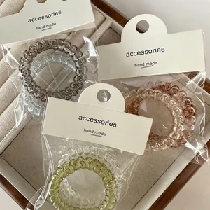 Three-pack jelly color spiral telephone wire hair ties with handmade card packaging