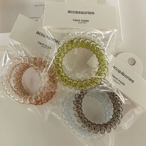 Detailed view of elastic spiral hair ties in jelly colors with premium card packaging