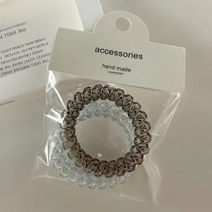 Elastic spiral hair ties in jelly blue and grey colors with a stylish minimalist design