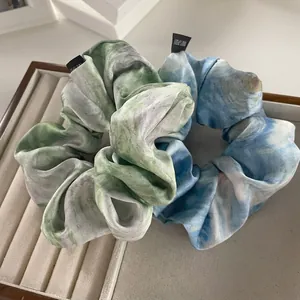 Elegant silk hair scrunchies with ink wash marble patterns in green and blue colors