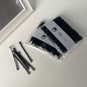 Set of 100 black wave bobby pins in transparent packaging for minimalist hair styling