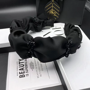 Elegant black satin pleated headband with sparkling crystal beads and a classic bow design