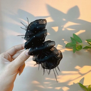 Elegant black tulle hair claw clip with feathers and rhinestones for a retro party style