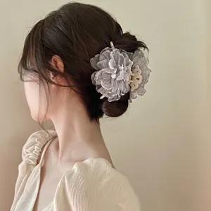 Elegant grey organza flower hair claw with central pearl on a beige base hair clip