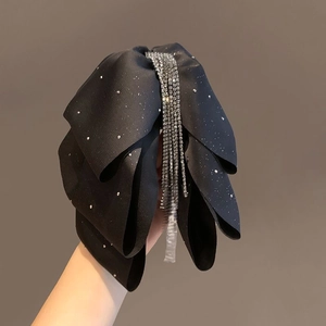 Elegant black bow hair claw clip featuring shimmering rhinestone tassels for women
