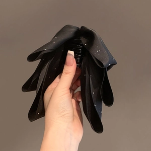 Elegant black satin bow hair claw clip with sparkling rhinestones for voluminous hairstyles