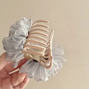 Detail of elegant organza flower hair claw clip with pearls in French retro style