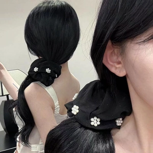 Elegant black scrunchie with white pearl flower decor for low ponytail hairstyles