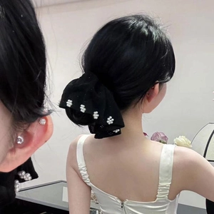 Elegant oversized black fabric scrunchie with white pearl accents for a low ponytail look