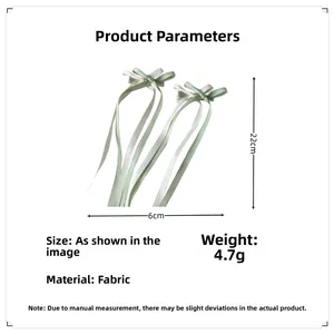 Detail view of ballet style ribbon bows with 22cm long streamers in green and white