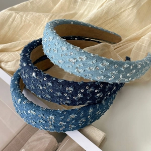 Detail of denim headbands with silver sequins and distressed edges in three blue shades
