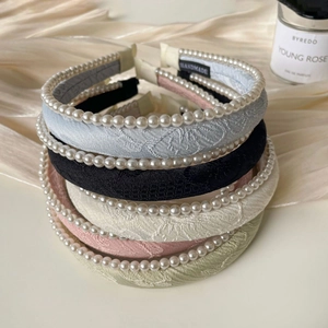 Detailed view of handmade jacquard headbands with pearls in five soft colors