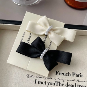 Elegant pearl bow hair clips set in black and creamy white satin for women