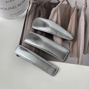 Three-piece set of silver faux leather hair clips in geometric teardrop and bar shapes