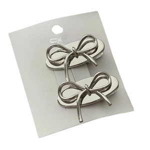 Set of two silver metallic bow hair clips with a minimalist polished finish